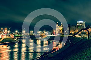 City at night with river reflections