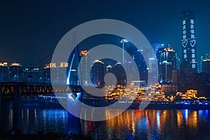 City night view of Chongqing, China.  The scenery by the river.  The fusion of modern architecture and folk architecture.  City vi