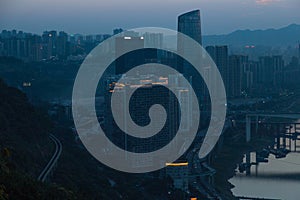 City night view of Chongqing, China after sunset. Skyscrapers on the banks of the Jialing River and the busy city traffic