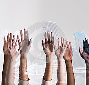 The city is in our hands. Shot of a city superimposed over an unidentifiable business team putting their hands up