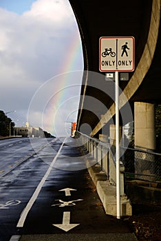 City: overpass and bike path with rainbow