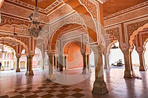 City Palace Jaipur ancient hallway with ancient wall art with columns at Rajasthan India