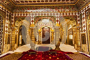 City Palace Jaipur royal room with gold artwork at Rajasthan, India