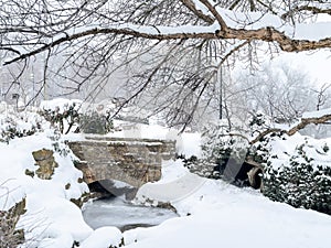 City Park in wither with sandstone bridge and snow