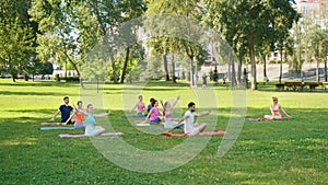 City park yoga: Group twists on mats