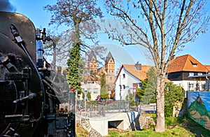 City with a passing steam locomotive. Dynamic due to motion blur