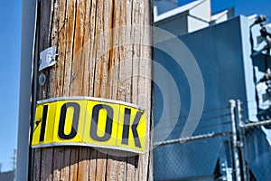 City Phone and Utility Pole with a Bright Yellow 100K tag