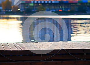 City pier with water reflections background