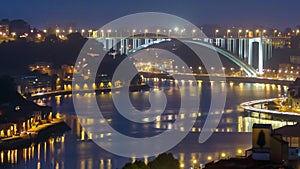 City of Porto and Gaia at night by the Douro river timelapse in Portugal, Arrabida Bridge at the far end.