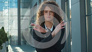 City portrait Caucasian dissatisfied business woman girl businesswoman strong serious lady showing crossed hands forbid