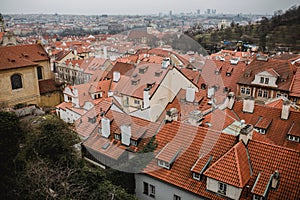 City of Prague with red roofs and Church in fog. City view of Praha old city. Rustic grey colors toning