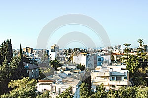 City with private houses and high-rise buildings on a background of sky