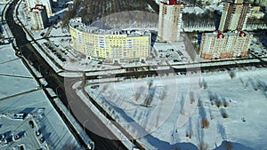 City quarters. Multi-story houses. Winter cityscape. Flight with a camera turn. Aerial photography.