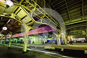 City railway station and passenger platform at night in St. Petersburg, Russia. Structure and roof of train station at twilight.