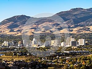 City of Reno Nevada cityscape with hotels and casinos with a blue sky.