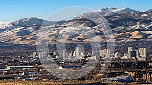 City of Reno Nevada cityscape with hotels, casinos, a blue sky with Mt. Rose and Slide mountain in the background. photo