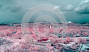 City of Reno Nevada cityscape with hotels, casinos, an overcast sky as seen from the south in false color infrared photography. photo
