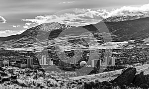 City of Reno Nevada cityscape with hotels and casinos and snow covered mountains in monochrome. photo