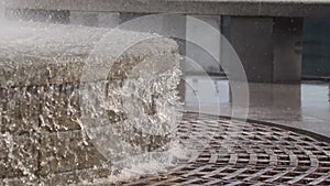 City round fountain on the embankment, waterfall, fountain close-up, water drops