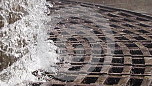 City round fountain on the embankment, waterfall, fountain close-up, water drops