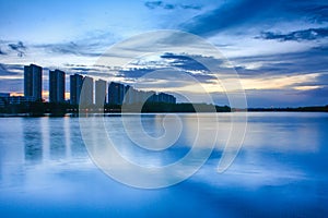 City scape at night with reflection on lake. Thailand. sunset wi