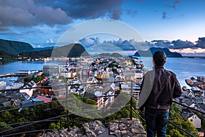 City Scene with A Lone Man Overlooking Alesund Center at Night