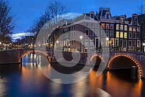 City scenic from Amsterdam at the canals in the Netherlands at night