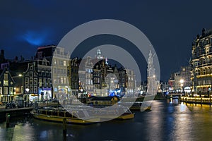 City scenic from Amsterdam by night with the Munt tower in the Netherlands photo