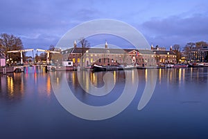 City scenic from Amsterdam at the river Amstel in the Netherlands at sunset