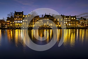 City scenic from Amsterdam at the river Amstel in the Netherlands at sunset