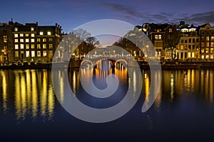 City scenic from Amsterdam at the river Amstel in the Netherlands at sunset