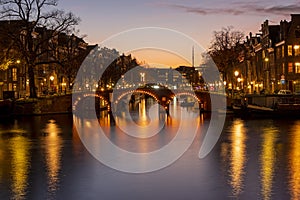 City scenic from Amsterdam at the river Amstel in the Netherlands at sunset