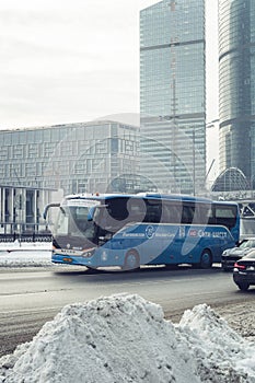 City-Shuttle blue bus on the street near Moscow International Business Center. Moskva-Siti district at winter. fast and convenient