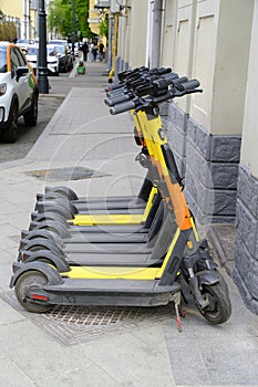 City sidewalks feature a plethora of electric scooters, catering to the demand for convenient, green transportation.