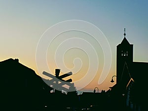 City silhouet with sunset and golden sky. Houses abd church.