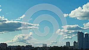 City sky time lapse. Panorama of downtown cityscape, skyscraper construction and blue summer sky with evaporating clouds time