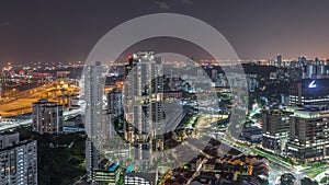 City skyline with commercial port of Singapore aerial night timelapse.