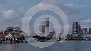 City skyline with skyscrapers and Esplanade Theatres on the Bay in Singapore at dusk, with beautiful reflection in water