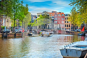 City skyline with water canal and tourist boats, Amsterdam, Netherlands