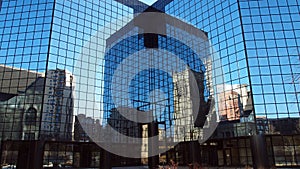 City skyscraper with mirror reflecting windows on a blue sky day photo