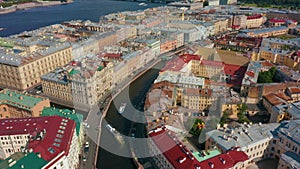 City St. Petersburg, cruise ships sail along river canal, old roofs of buildings