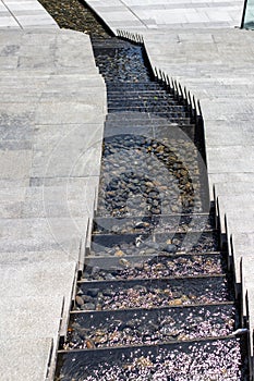 City stream. Water cascade. Steps down and in the middle, water flows down the steps. Modern designer steps