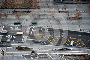 City street with asphalt road and white and yellow marking lines and arrows and signs.