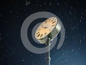 City street clock on the background of the starry sky.