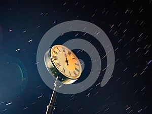 City street clock on the background of the starry sky.