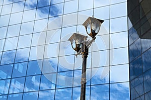 City street lamp against a glass wall