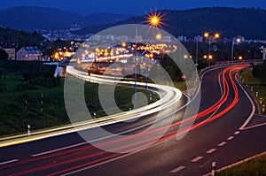 The city with street lighting in the valley at night, the light path headlights of cars