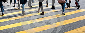 city street with a motion blurred crowd crossing a road