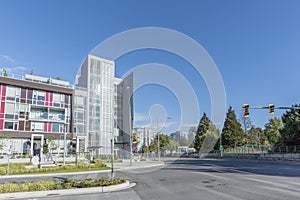 city street with new modern buildings, glass windows, streetlights