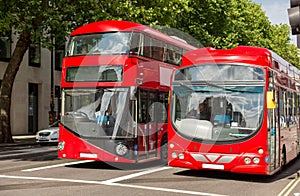 City street with red double decker buses in london